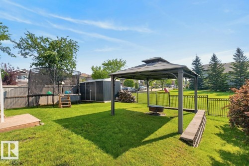Expansive backyard featuring a gazebo, manicured lawn, and a metal storage shed - 109 Selkirk Place, Leduc, AB - Outdoor With Backyard