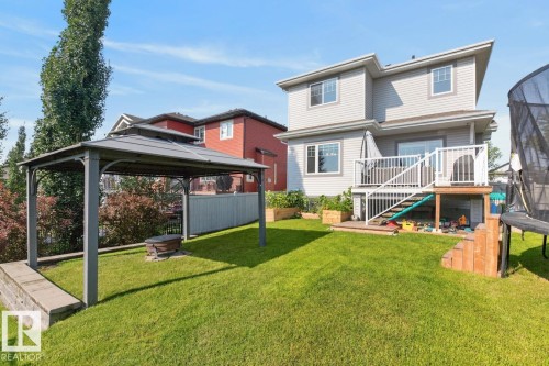 Spacious backyard featuring a substantial lawn, a covered gazebo, and a multi-level deck with white railings - 109 Selkirk Place, Leduc, AB - Outdoor With Deck Patio Veranda