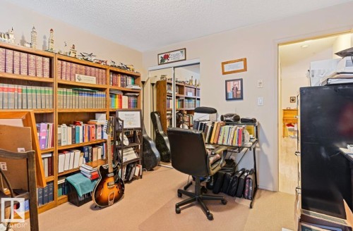Warm-toned carpeting throughout - #203 17407 99 Av Nw, Edmonton, AB - Indoor Photo Showing Office