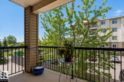 Private balcony with textured concrete flooring and black metal railings - #203 17407 99 Av Nw, Edmonton, AB - Outdoor With Exterior