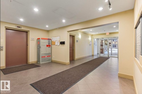 Common area lobby featuring neutral-toned walls and large format tile flooring - #203 17407 99 Av Nw, Edmonton, AB - Indoor
