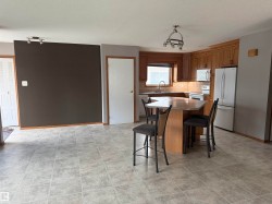 Kitchen featuring wood-finish cabinetry, a built-in microwave, and a double-door refrigerator - 