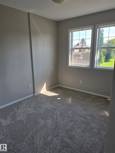Room featuring neutral-toned walls and plush gray carpeting - 4120 47 Street, Drayton Valley, AB - Indoor Photo Showing Other Room