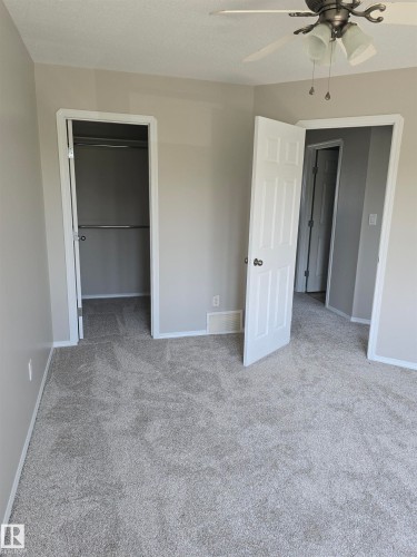 Room featuring light gray walls, white trim, and gray carpeting - 4120 47 Street, Drayton Valley, AB - Indoor