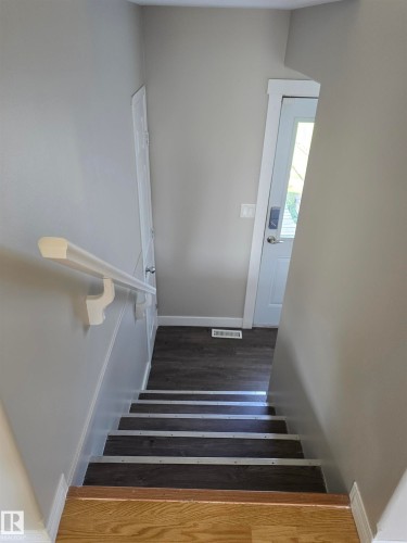 Stairwell featuring light gray walls and wood-finish flooring - 4120 47 Street, Drayton Valley, AB - Indoor Photo Showing Other Room