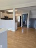 Open-concept living area featuring wood-finish flooring, white baseboards, and neutral wall tones - 4120 47 Street, Drayton Valley, AB  - Indoor Photo Showing Kitchen 