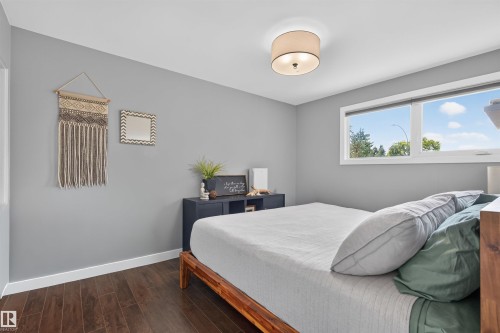 Bedroom featuring wood-finish flooring, light gray wall tones, and white baseboards - 12136 135A Avenue Nw, Edmonton, AB - Indoor Photo Showing Bedroom