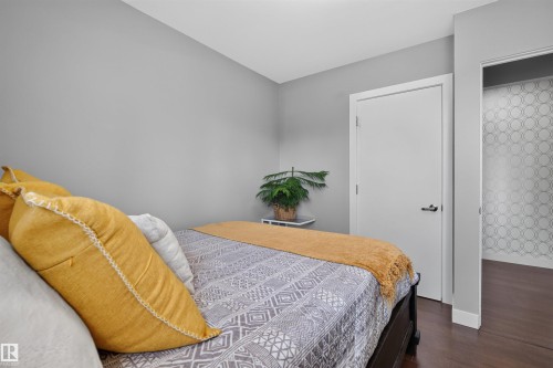 Room featuring neutral gray walls and dark wood-finish flooring - 12136 135A Avenue Nw, Edmonton, AB - Indoor Photo Showing Bedroom