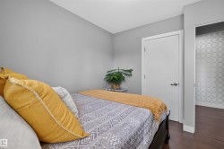 Room featuring neutral gray walls and dark wood-finish flooring - 