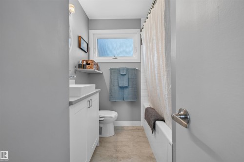 Bathroom featuring a white vanity with a rectangular vessel sink, light gray countertop, and contemporary hardware - 12136 135A Avenue Nw, Edmonton, AB - Indoor Photo Showing Bathroom