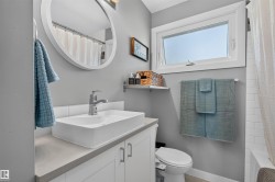 Bathroom vanity with a rectangular vessel sink, chrome faucet, and concrete-finish countertop - 