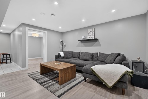 Recessed lighting illuminating a spacious room with light wood-finish flooring - 12136 135A Avenue Nw, Edmonton, AB - Indoor