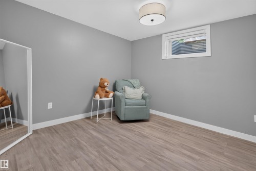 Room featuring light gray walls and wood-finish flooring - 12136 135A Avenue Nw, Edmonton, AB - Indoor