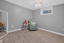 Room featuring light gray walls and wood-finish flooring - 