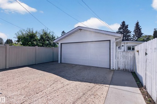 Detached garage featuring a white overhead door and siding - 12136 135A Avenue Nw, Edmonton, AB - Outdoor