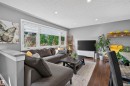 Spacious living area featuring large windows, recessed lighting, and wood-finish flooring - 12136 135A Avenue Nw, Edmonton, AB  - Indoor Photo Showing Living Room With Fireplace 