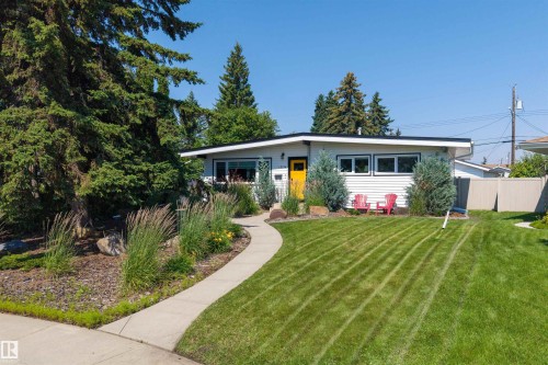 Front exterior featuring white horizontal siding and a dark trim - 12136 135A Avenue Nw, Edmonton, AB - Outdoor