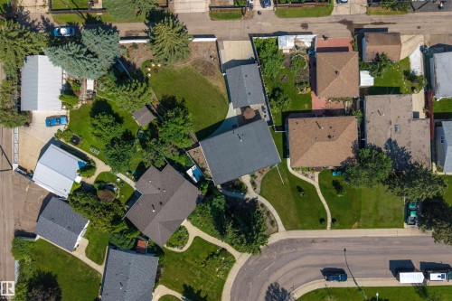 Residential neighborhood featuring single-family homes with pitched roofs, mature trees, and paved streets - 12136 135A Avenue Nw, Edmonton, AB - Outdoor With View