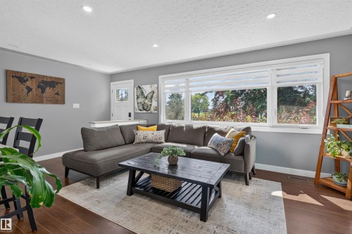 Living area featuring wood-finish flooring and recessed lighting - 12136 135A Avenue Nw, Edmonton, AB - Indoor Photo Showing Living Room