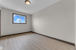Room featuring light wood-finish flooring, a neutral wall color, and dark trim - 