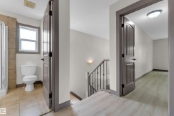 Bathroom featuring a window, tile flooring, and a shower enclosure - 