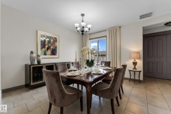 Dining area featuring ceramic tile flooring, a multi-pane window with drapes, and a black chandelier - 
