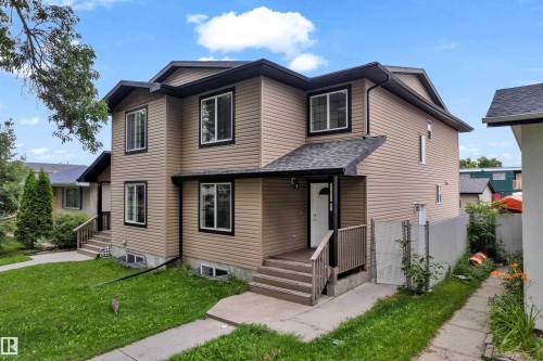 Two-story exterior with light brown siding and contrasting dark trim - 11817 37 Street Nw, Edmonton, AB - Outdoor