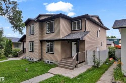 Two-story exterior with light brown siding and contrasting dark trim - 