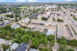 Extensive urban landscape featuring a mix of residential and commercial structures, mature trees, and developed infrastructure - 