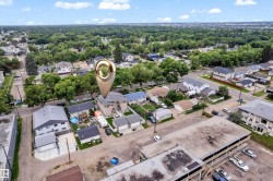 Residential neighborhood with mature trees and a mix of single-family homes and multi-story buildings - 