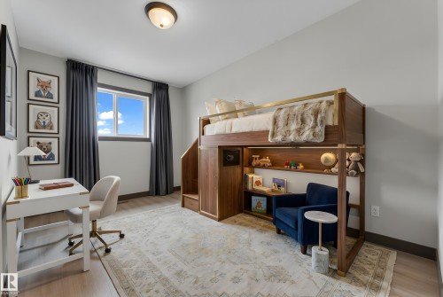 Light gray walls and wood-finish flooring define this room, featuring a built-in loft bed with integrated shelving - 11817 37 Street Nw, Edmonton, AB - Indoor Photo Showing Office