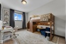 Light gray walls and wood-finish flooring define this room, featuring a built-in loft bed with integrated shelving - 11817 37 Street Nw, Edmonton, AB  - Indoor Photo Showing Office 