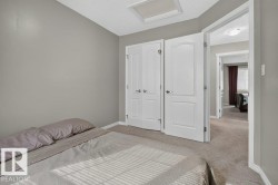 Neutral-toned bedroom with textured carpet flooring - 