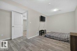Room featuring light gray walls and wood-finish flooring - 