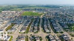 Aerial perspective showcasing a residential community with single-family homes and multi-family buildings - 