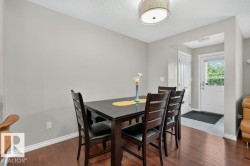 Dining area featuring wood-finish flooring and neutral wall tones - 