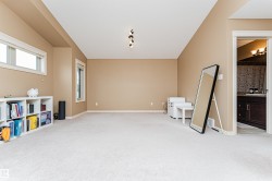 Spacious room featuring neutral carpeting and tan wall paint - 