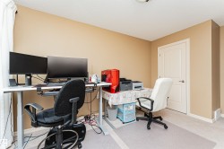 Flexible room featuring light beige walls and carpeting, a white paneled door, and white baseboards - 