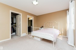 Carpeted room with neutral tone walls and white trim - 