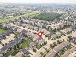 Aerial perspective showcasing a residential neighborhood with detached homes and tree-lined streets - 