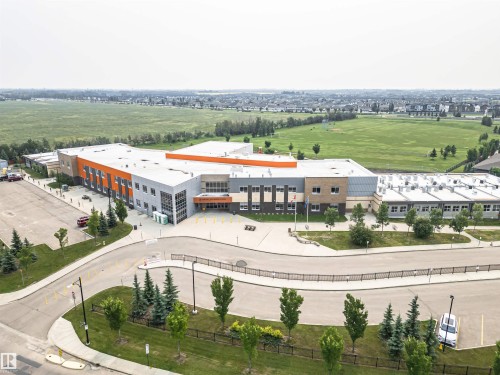 Modern institutional building with multi-toned facade, featuring orange, grey, and brown accents - 2605 Anderson Crescent Sw, Edmonton, AB - Outdoor With View