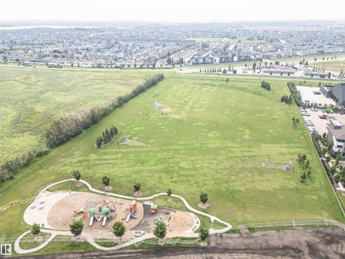 Expansive green space featuring a large playground with multiple structures, winding paved pathways, and mature trees - 2605 Anderson Crescent Sw, Edmonton, AB - Outdoor With View