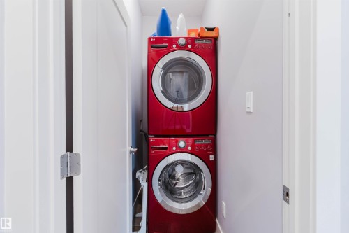 Dedicated laundry area featuring a stacked, front-loading washer and dryer set - 10626 81 Avenue Nw, Edmonton, AB - Indoor Photo Showing Laundry Room