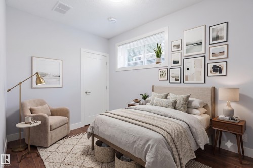 Interior room featuring wood-finish flooring, a white trim door, and a horizontal window with blinds - 10626 81 Avenue Nw, Edmonton, AB - Indoor Photo Showing Bedroom