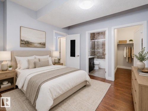 Spacious room featuring wood-finish flooring, a built-in closet, and an attached bathroom with a tiled shower - 10626 81 Avenue Nw, Edmonton, AB - Indoor Photo Showing Bedroom