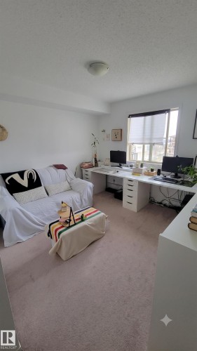 Neutral wall finishes and light-toned carpet flooring - #415 12045 22 Av Sw, Edmonton, AB - Indoor