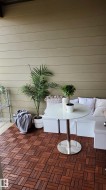 Outdoor living space featuring rich wood-finish flooring - 