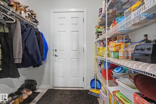 Mudroom featuring a paneled door, wire shelving, and a built-in hanging rod - 22419 80 Avenue Nw, Edmonton, AB - Indoor With Storage