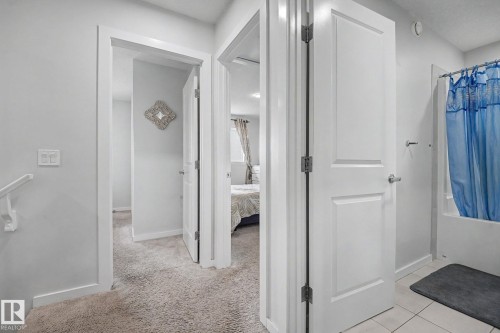 Upper-level hallway featuring light gray wall paint, carpeting, and white trim - 22419 80 Avenue Nw, Edmonton, AB - Indoor Photo Showing Other Room
