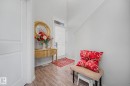 Entryway with wood-finish flooring, white paneled door, and a partially visible staircase - 22419 80 Avenue Nw, Edmonton, AB  -  Photo Showing Other Room 